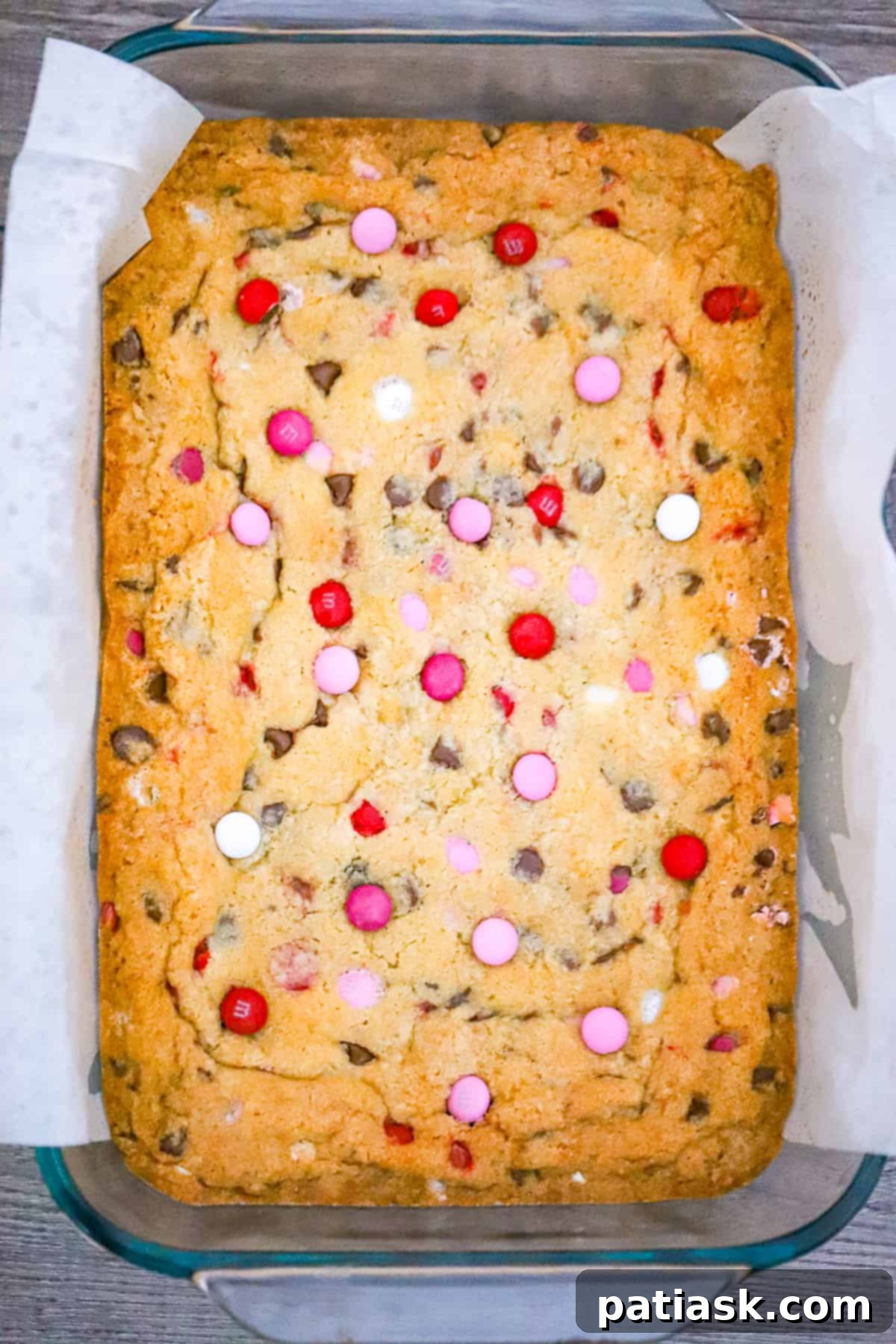 Fudgy Valentine M and M Bars 6 Sheet pan filled with freshly baked Valentine M&M cookie bars, golden brown and covered in colorful candies.
