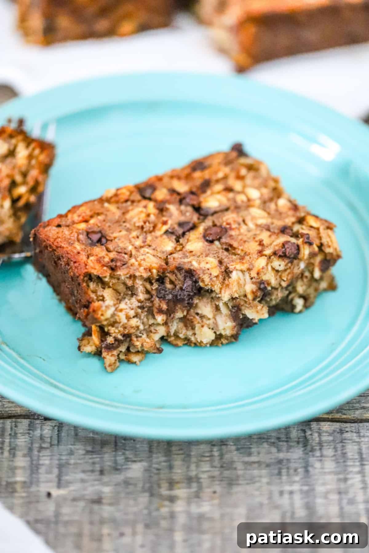 Wholesome Banana Chocolate Chip Baked Oats 7 Divine Healthy Banana Chocolate Chip Baked Oatmeal recipe: a vegan, protein-packed, fiber-rich breakfast option, close up shot