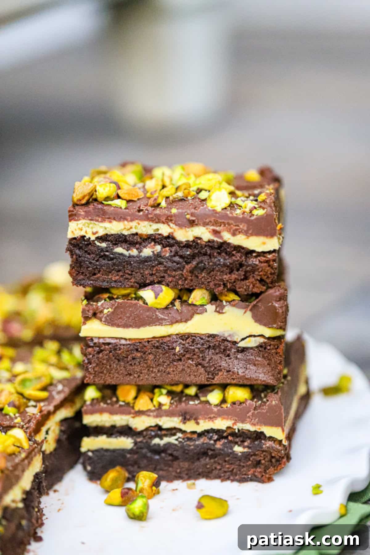 Our decadent Pistachio Brownies recipe is the best! Imagine biting into a fudgy and moist brownie, only to be surprised by a creamy pistachio white chocolate ganache filling. And just when you thought it couldn't get any better, a layer of smooth chocolate ganache and crunchy pistachios on top. Are you drooling yet?
