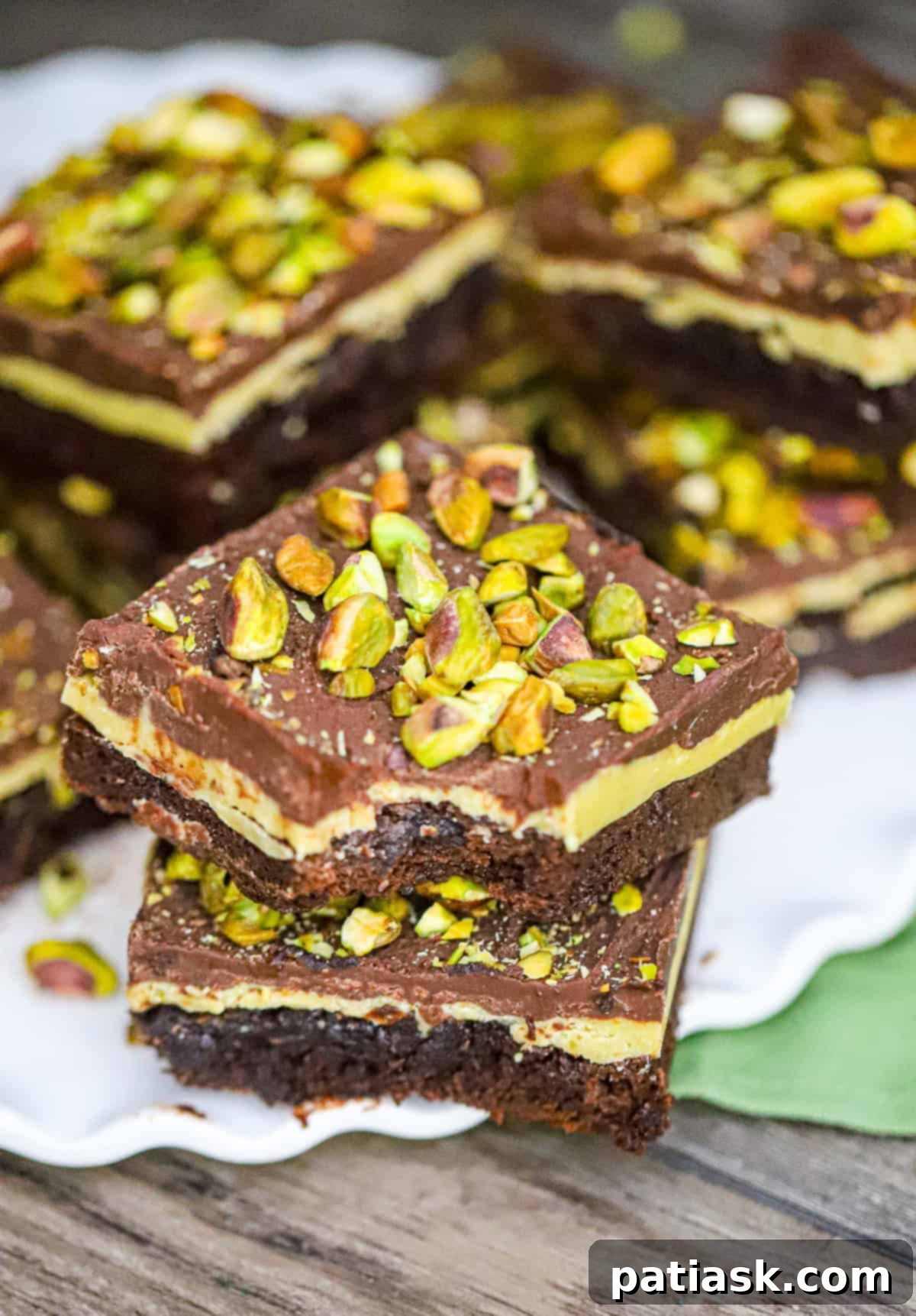 Our decadent Pistachio Brownies recipe is the best! Imagine biting into a fudgy and moist brownie, only to be surprised by a creamy pistachio white chocolate ganache filling. And just when you thought it couldn't get any better, a layer of smooth chocolate ganache and crunchy pistachios on top. Are you drooling yet?