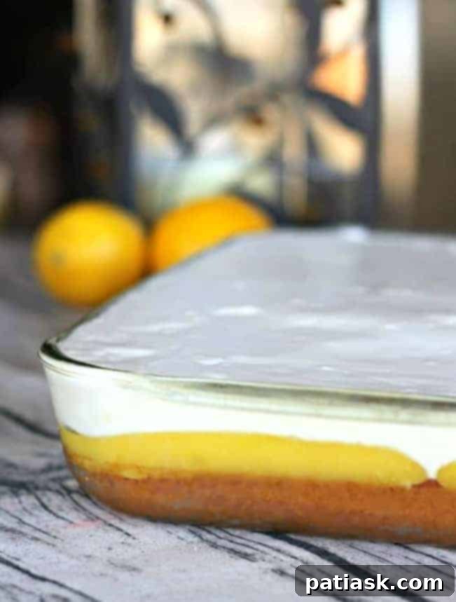A full Lemon Burst Poke Cake in a baking pan, ready to be served