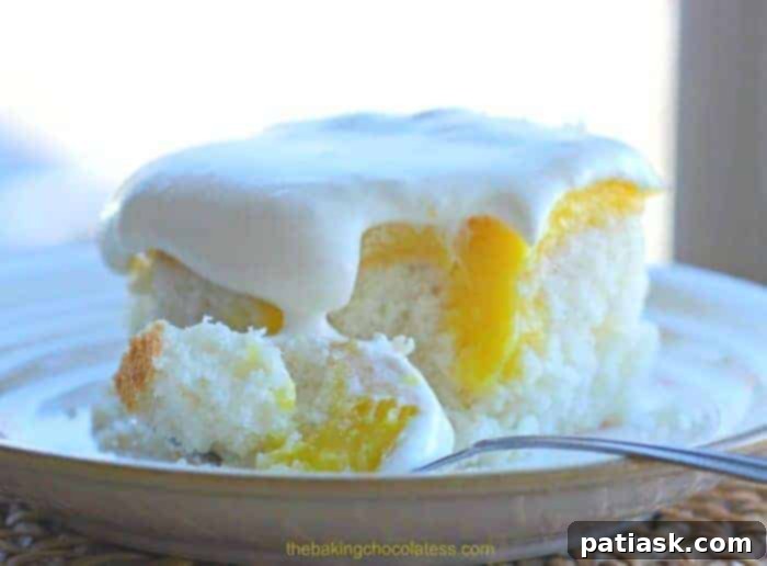 Beautifully garnished Lemon Burst Poke Cake, ready for serving at a summer gathering