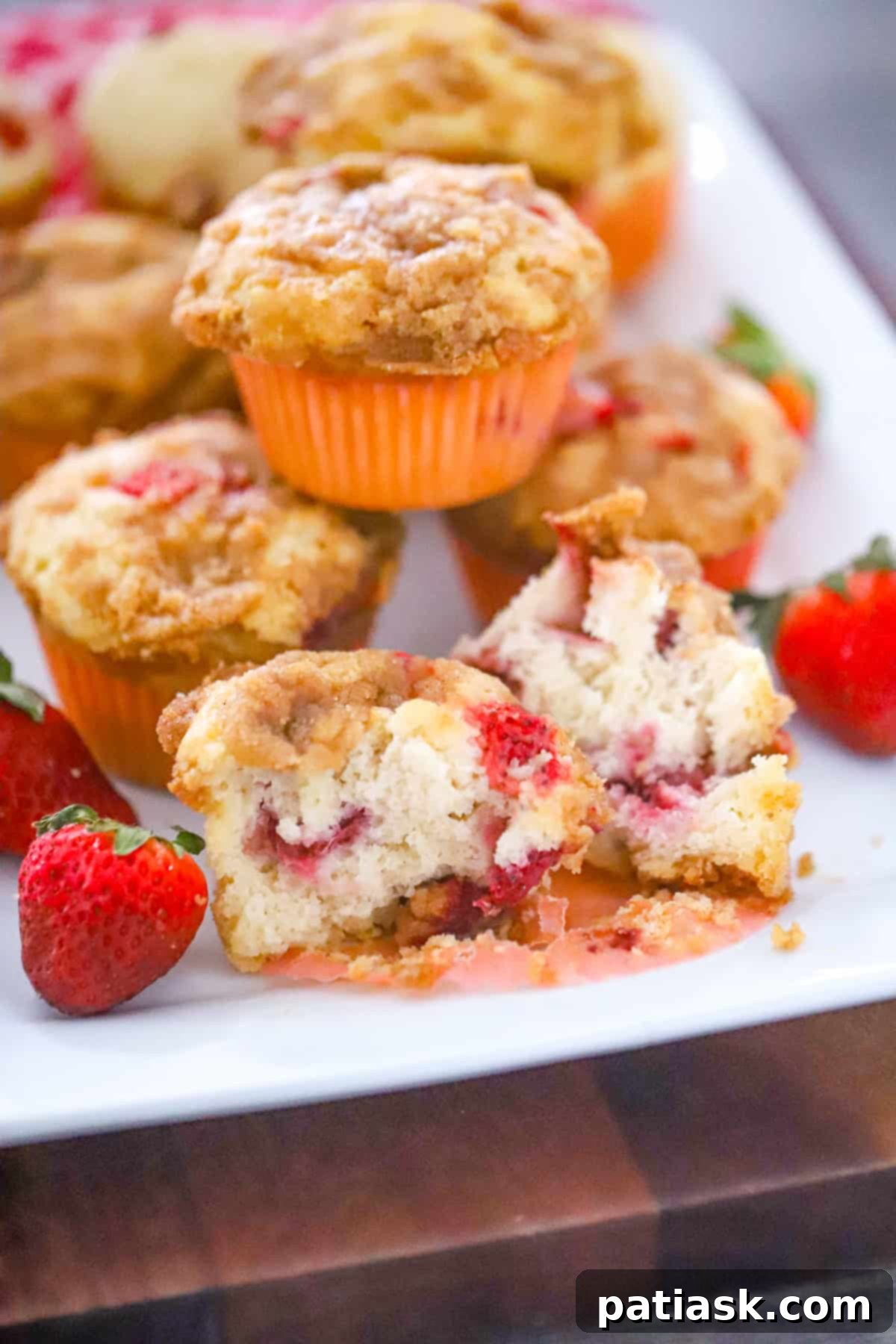 Top view of strawberry streusel cobbler muffins on a plate