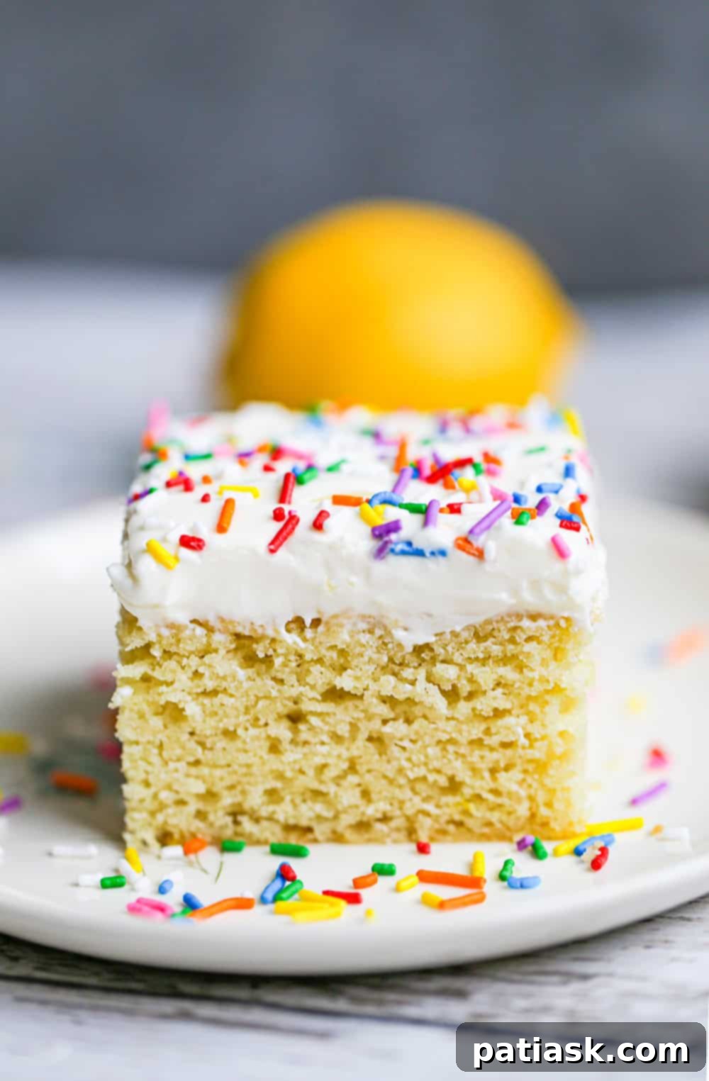 Zesty Lemon Cake 2 Bright and zesty lemon snack cake with vanilla frosting and sprinkles, perfect for a quick and easy dessert.