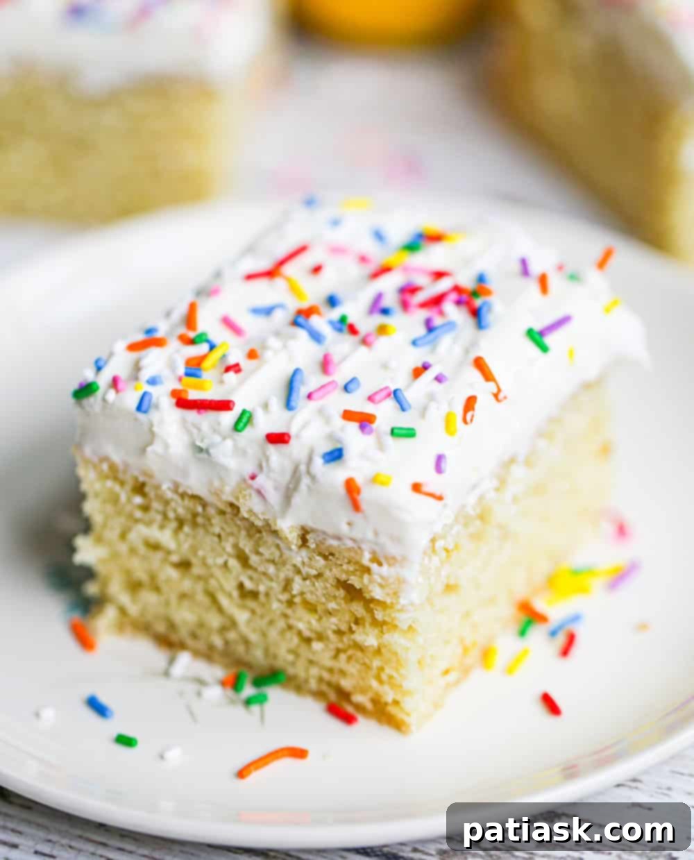 Zesty Lemon Cake 6 Multiple slices of lemon snack cake, some frosted and some plain, arranged on a serving platter.