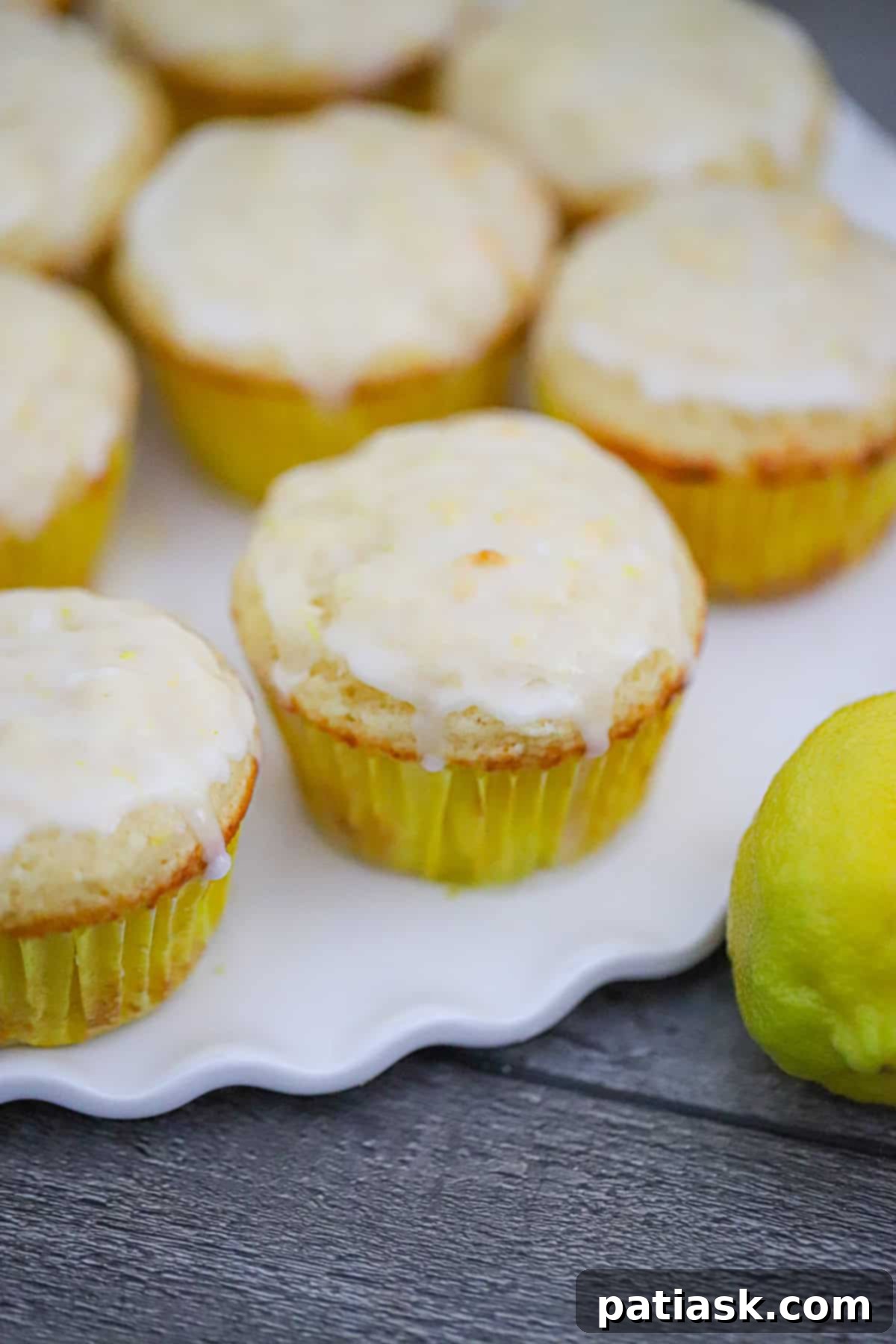 Tangy Lemon Yogurt Muffins 2 Deliciously moist lemon yogurt muffins with a bright yellow glaze