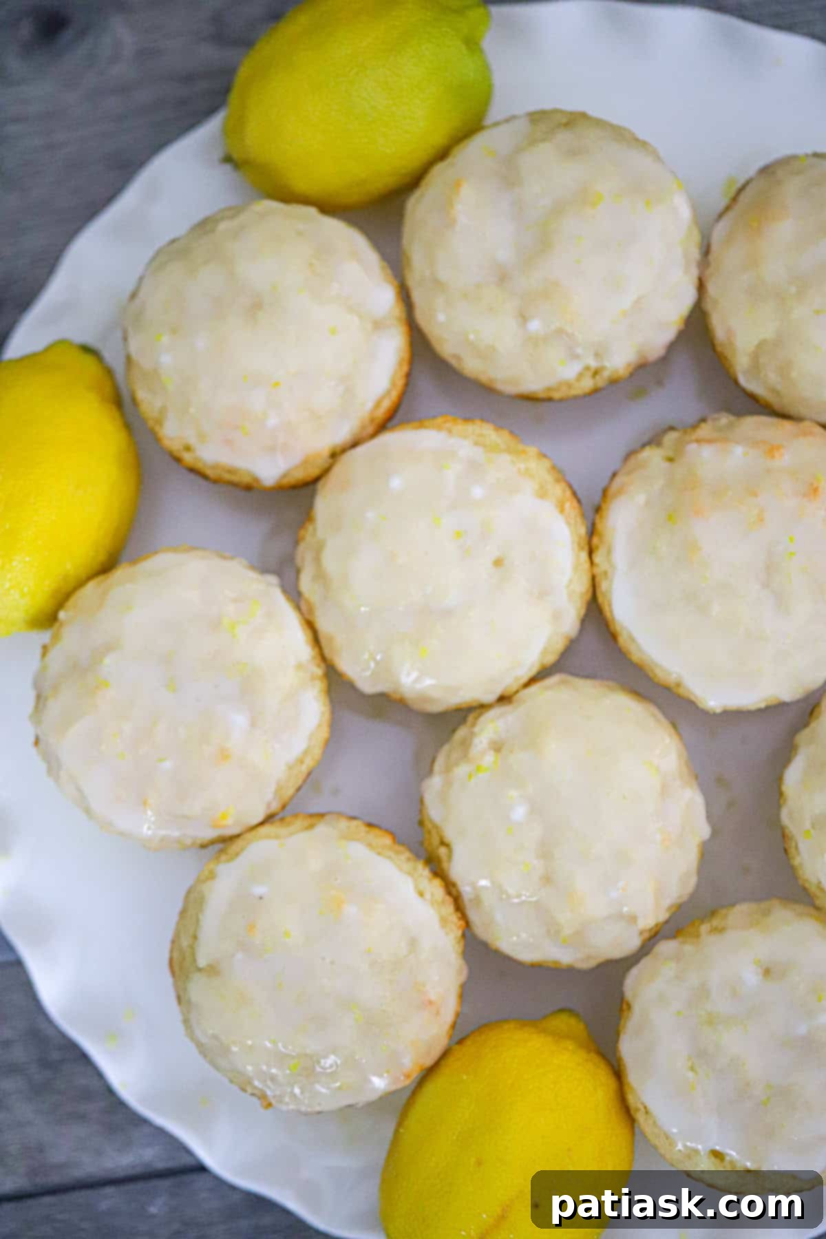 Tangy Lemon Yogurt Muffins 4 Freshly baked lemon yogurt muffins cooling on a wire rack