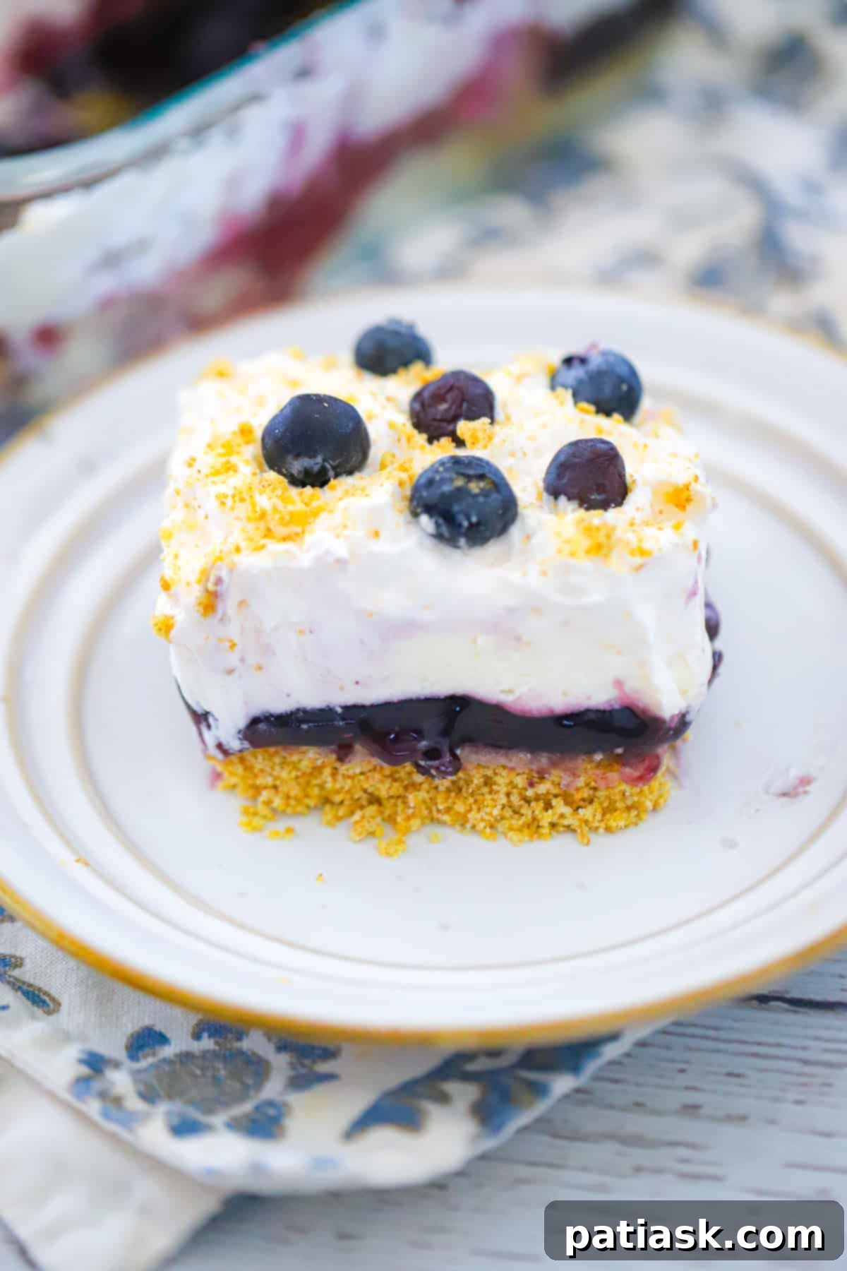 Effortless Blueberry Cheesecake Dream 2 Easy Blueberry Cheesecake Delight layered dessert recipe with graham cracker crust and whipped cream topping