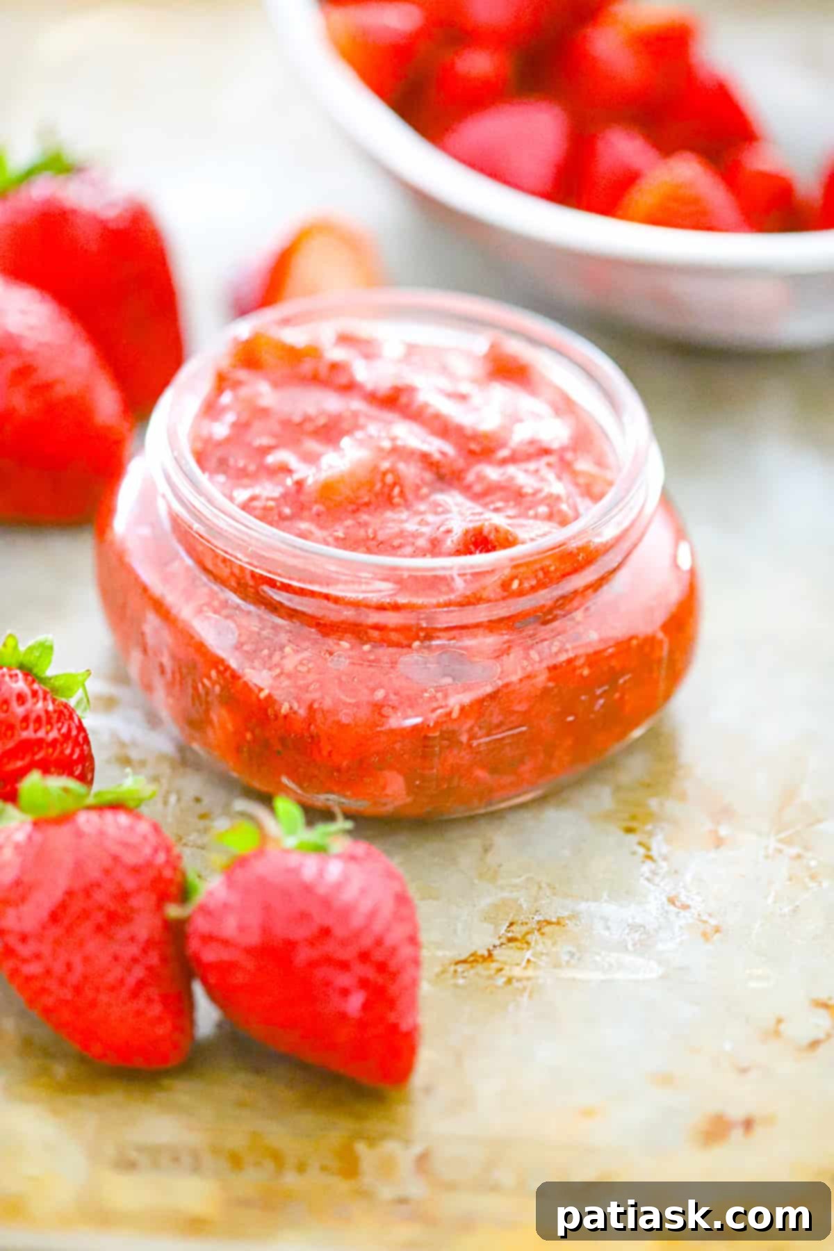 Wholesome Strawberry Chia Jam 7 STRAWBERRY CHIA JAM in a jar with fresh strawberries and mint