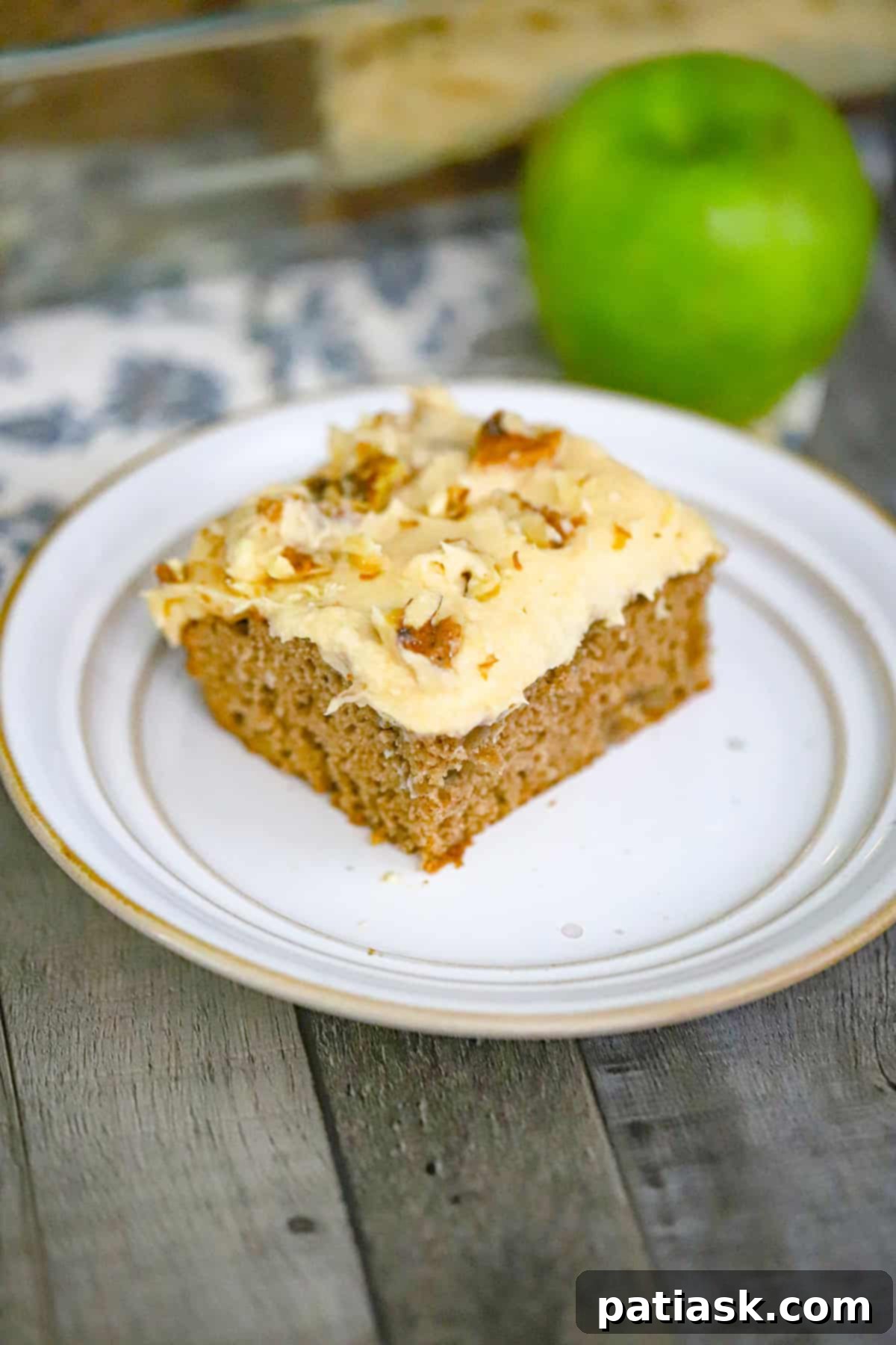 Autumn Apple Spice Cake with Creamy Caramel 2 Apple spice cake with caramel frosting and apple filling, sliced and ready to serve