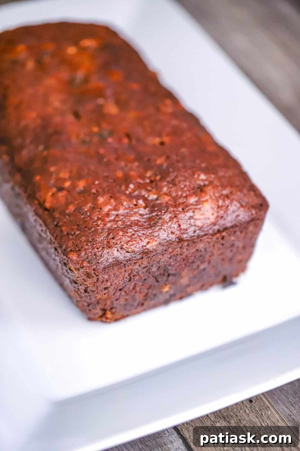 Grandma's Date Nut Bread 5 Cooling loaf on a wire rack after baking, hinting at its delicious warmth