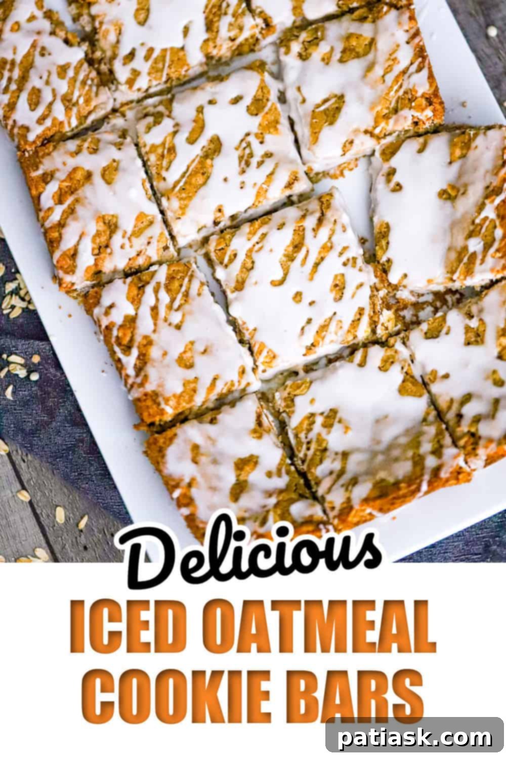 Frosted Oatmeal Bliss Bars 10 An overhead shot of a large batch of iced oatmeal cookie bars, showcasing their even size and delicious white icing.