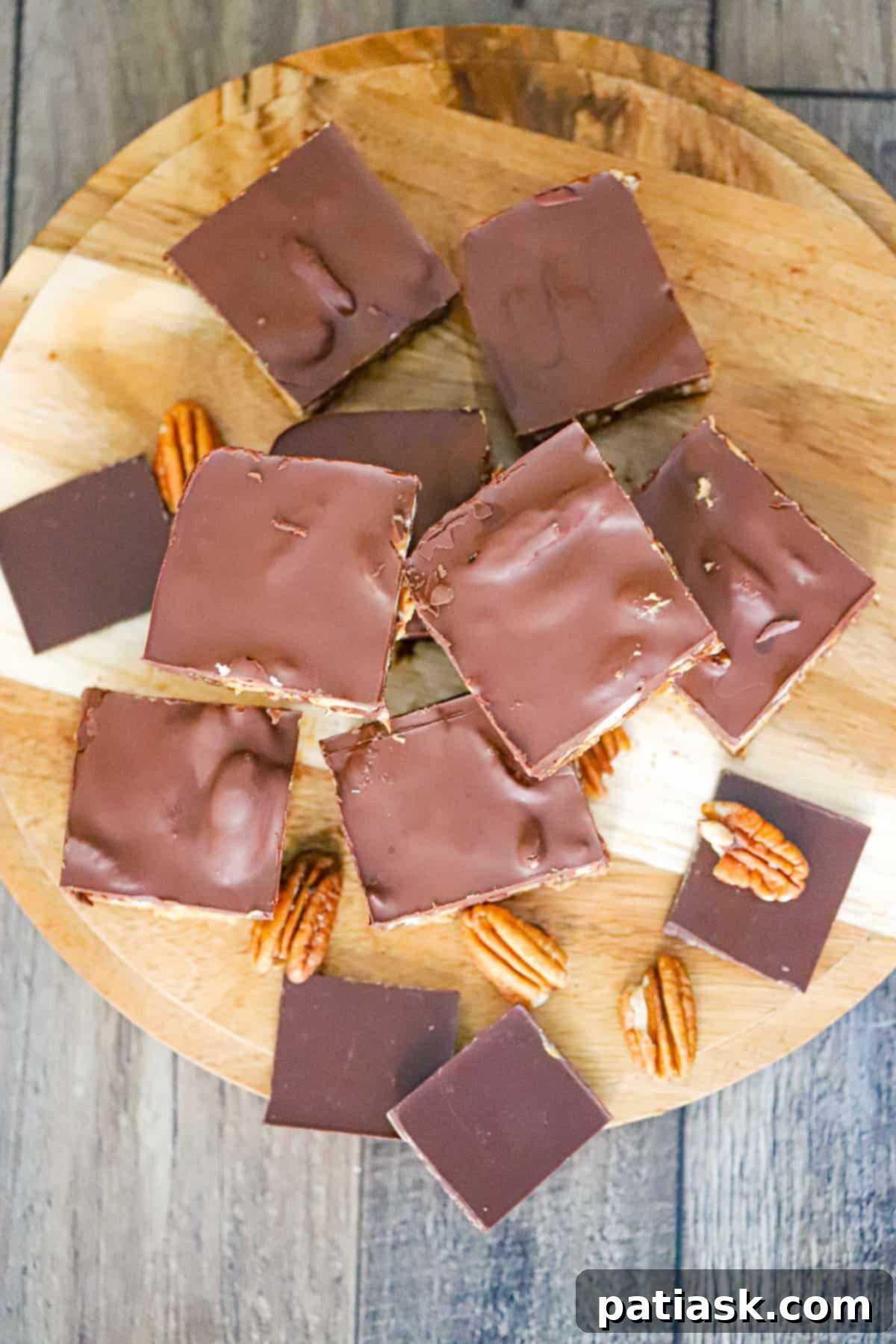 Guilt-Free Date Turtle Treats 6 A close-up shot of a healthy vegan dessert bar with dates, chocolate, and pecans.