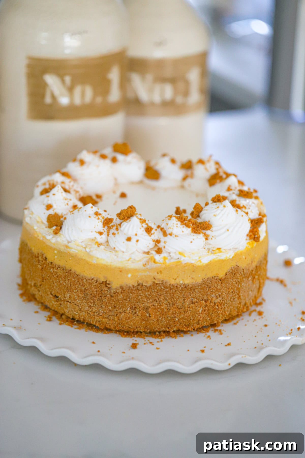 Autumn Spiced Pumpkin Biscoff Cheesecake 3 Close-up of a creamy Pumpkin Biscoff Cheesecake slice with a thick cookie crust