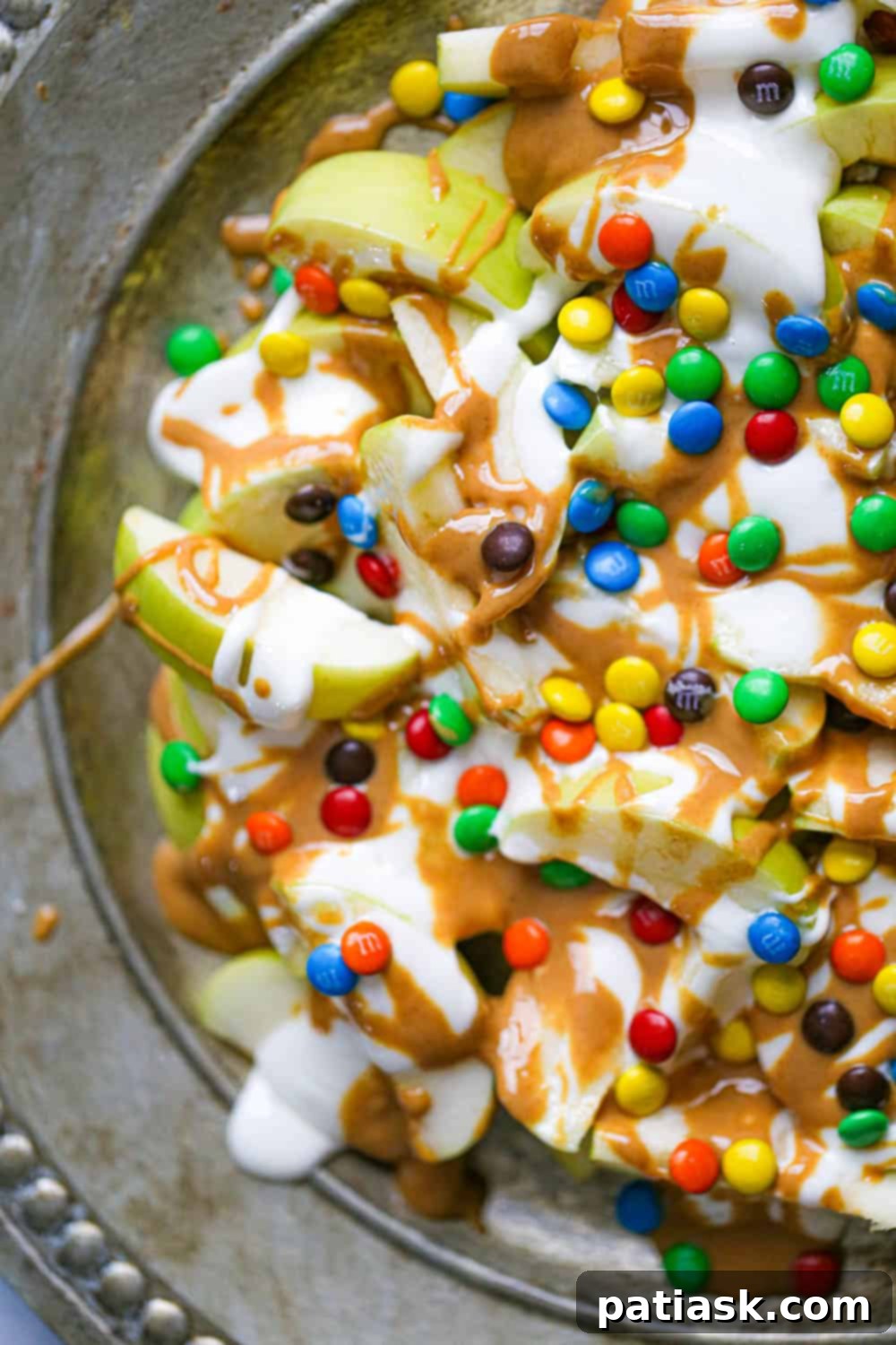 Fluffernutter Apple Delight 4 Overhead view of fully loaded Fluffernutter Apple Nachos on a white plate