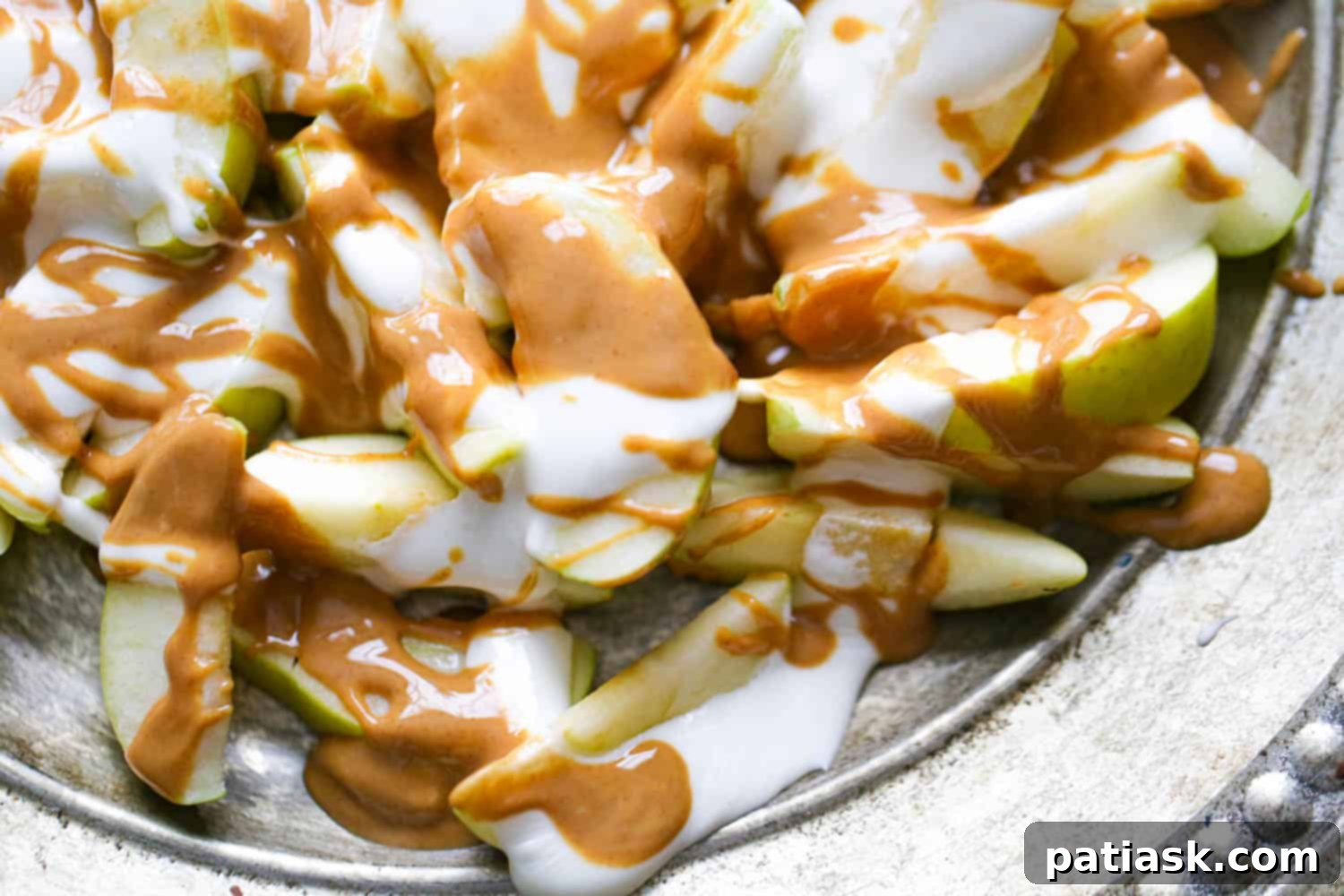 Fluffernutter Apple Delight 3 Close up of Fluffernutter Apple Nachos with melted marshmallow and peanut butter