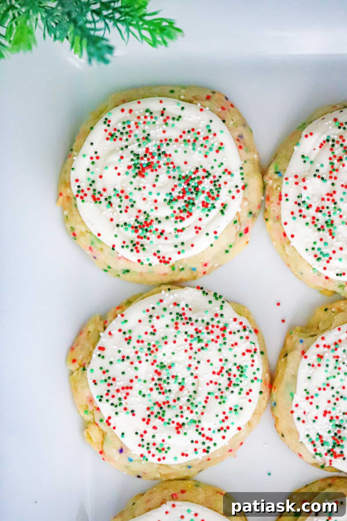 Christmas Crumbl Sugar Treats 2 frosted christmas sugar crumbl cookies with sprinkles