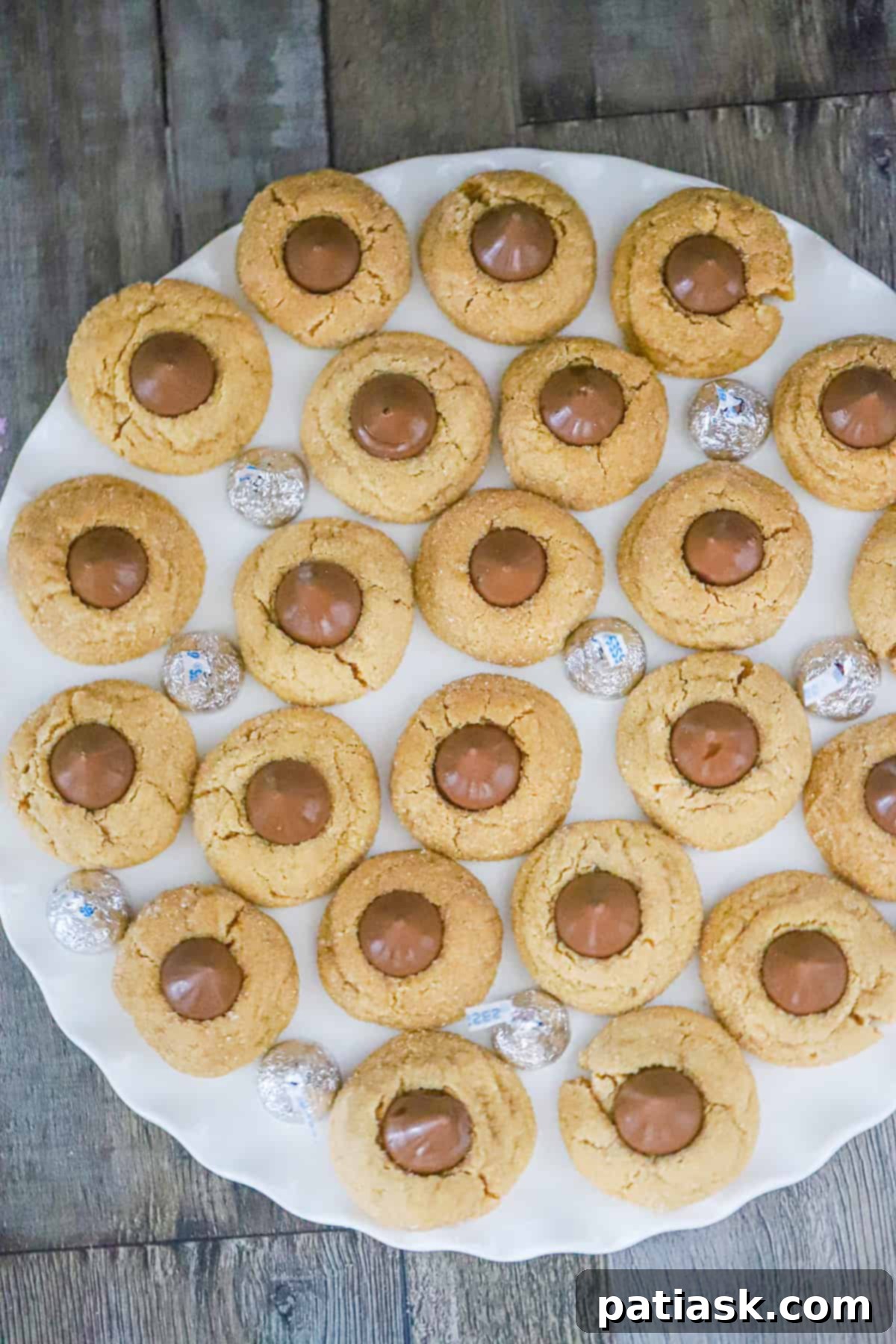 Peanut Butter Kiss Cookies 6 Close-up shot of irresistible peanut butter blossom cookies, highlighting their texture and chocolatey goodness.