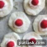 Heavenly Raspberry White Chocolate Sharing Rolls 9 Layering the biscuit dough with cream cheese and a raspberry for Skillet Pull-Apart Rolls