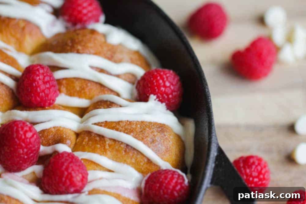 Heavenly Raspberry White Chocolate Sharing Rolls 4 Skillet Raspberry-White Chocolate Pull-Apart Rolls, showing the beautiful presentation in a cast iron skillet before serving.