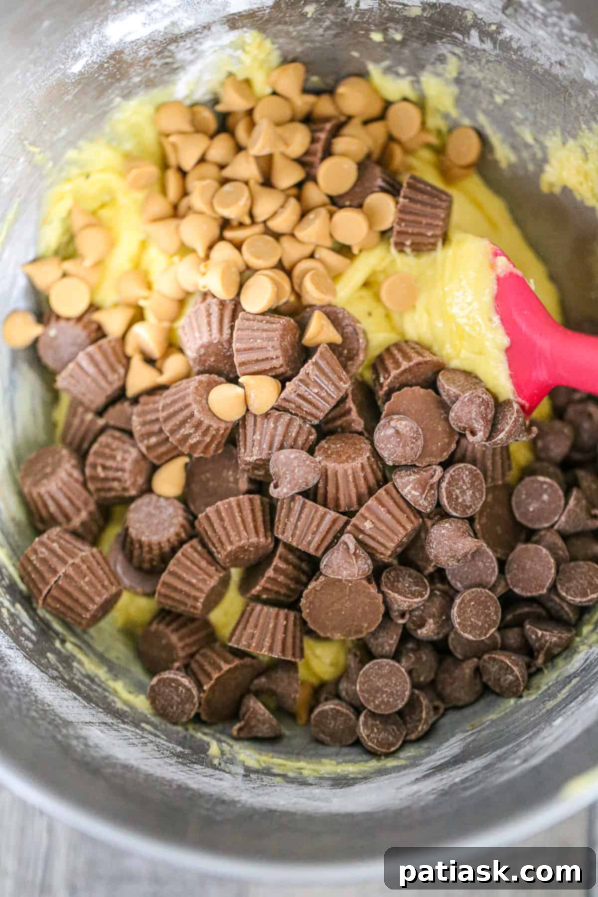 Irresistible Reese's Cookie Bars 5 Reese's Chocolate Chip Cake Mix Cookie dough in a bowl
