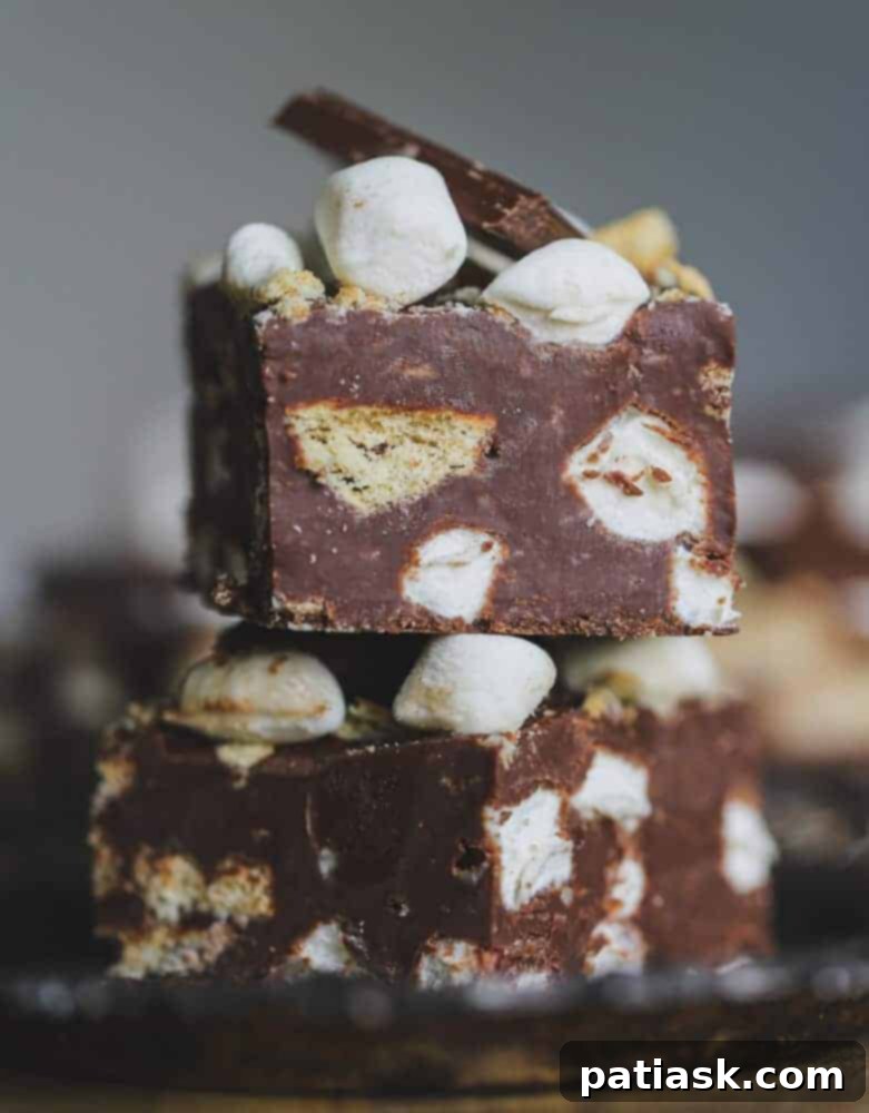 Effortless S'mores Fudge 3 Close-up of freshly made S'mores Fudge slices, showing layers of chocolate, marshmallow, and graham cracker