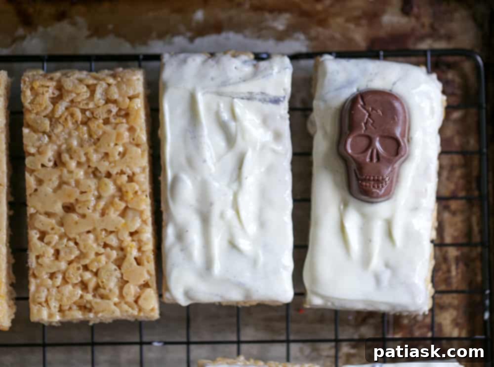 Tombstone Butterfinger Peanut Butter Skull Delights 7 A tray of finished Butterfinger Skull Tombstone Treats with chocolate 'RIP' lettering