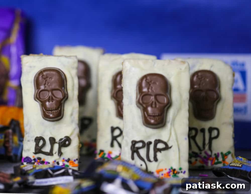 Tombstone Butterfinger Peanut Butter Skull Delights 9 A spooky display of Butterfinger Skull Tombstone Treats with various Halloween decorations