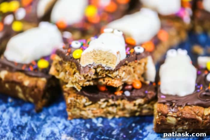 Spooktacular Reeses Monster Cookie Bars 3 Flourless Halloween Reese's Monster Cookie Bars with a chocolate peanut butter topping and Reese's Ghosts, highlighting the festive and easy nature of the recipe.