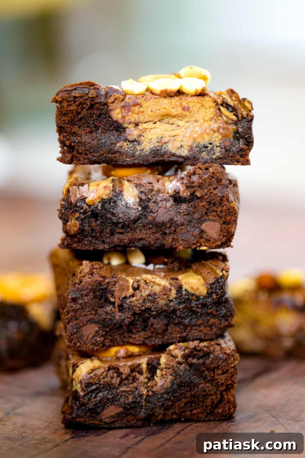 Decadent Nutella and Peanut Butter Cup Brownies 6 Close-up of a brownie square with a visible peanut butter cup melted inside