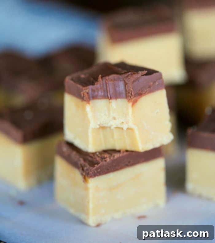 No-Fuss Buckeye Fudge 3 Creamy microwaveable chocolate peanut butter buckeye fudge slices on a white platter