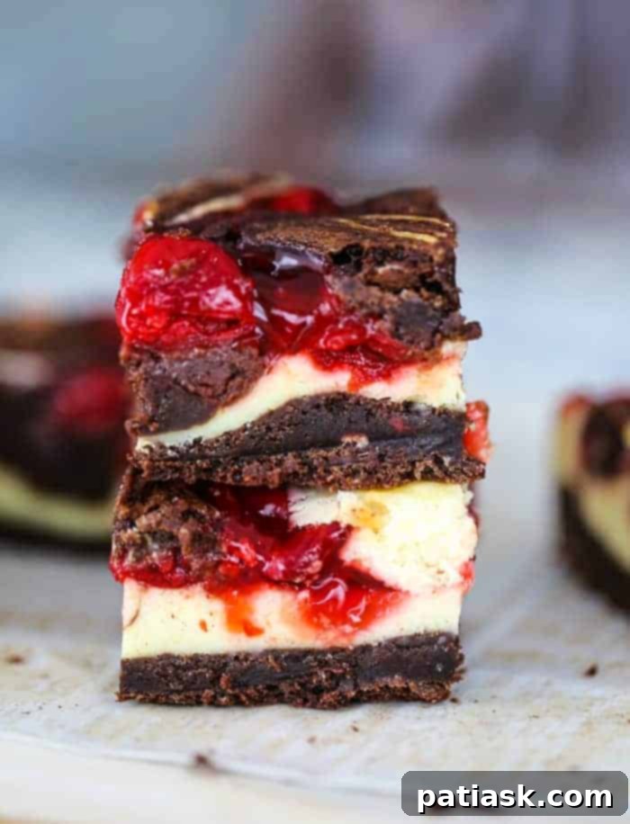 Best easy homemade Cherry Cheesecake Swirl Brownies recipe cut into perfect squares, ready to be served.