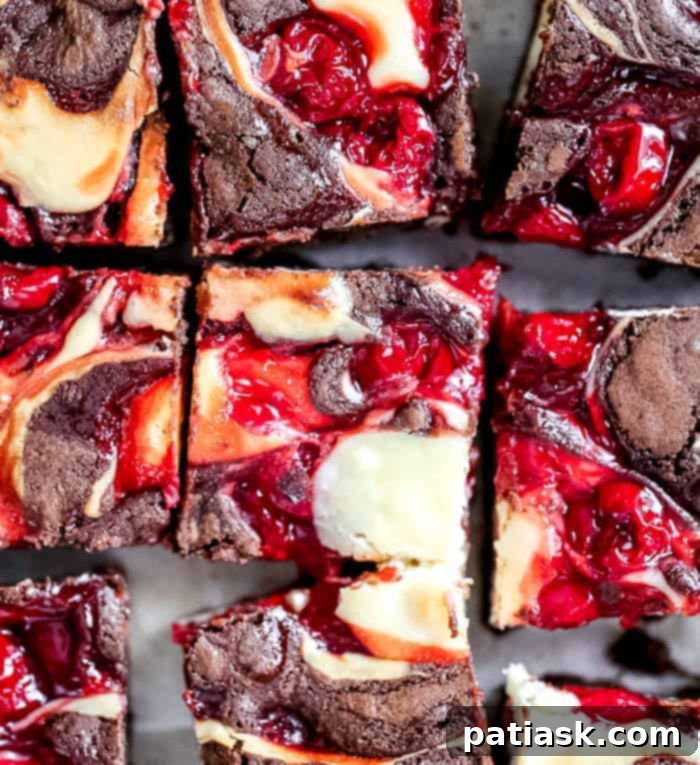 Best easy homemade Cherry Cheesecake Swirl Brownies recipe on a cooling rack, glistening with its delicious topping.