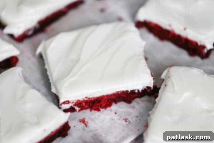Red velvet cookie bars recipe ingredients laid out, including flour, butter, sugar, and food coloring