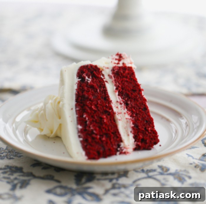 slice of best red velvet cake recipe with cream cheese frosting