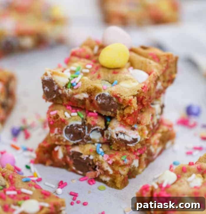 Delicious Cadbury Egg Cookie Bars on a sheet pan, adorned with festive sprinkles and white chocolate, perfect for Easter and spring celebrations