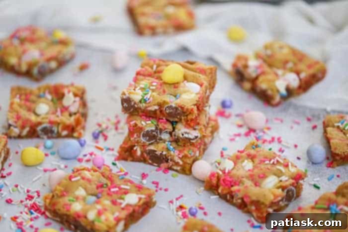 Sheet pan filled with warm, freshly baked Cadbury Egg Cookie Bars, still in the pan before cutting, promising easy serving