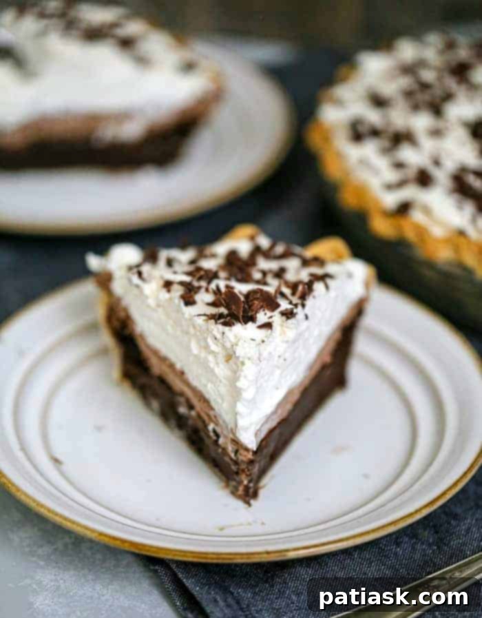 Ultimate Triple Layer Chocolate Brownie Mousse Cream Pie featuring a slice with visible layers of brownie, mousse, and whipped topping.