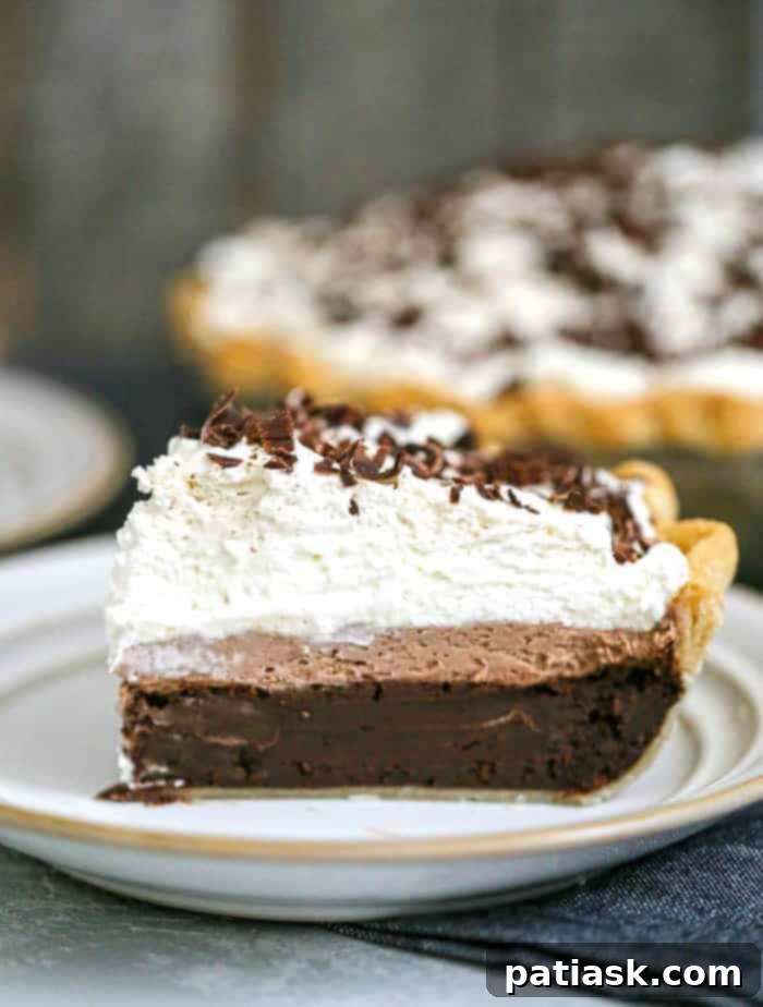 A top-down view of the Ultimate Triple Layer Chocolate Brownie Mousse Cream Pie, artfully decorated with chocolate shavings.