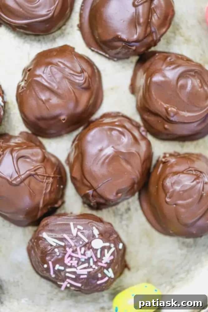 Easter Brunch Desserts So Heavenly, You'll Rise to the Occasion 4 A close-up of homemade vegan chocolate peanut butter eggs, showcasing their rich chocolate coating and a glimpse of the creamy peanut butter filling.