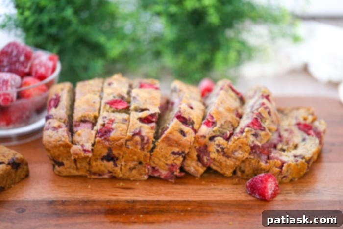 Strawberry Swirl Banana Walnut Loaf 5 A slice of Banana Strawberry Walnut Bread showing its delicious interior with fruit and nuts