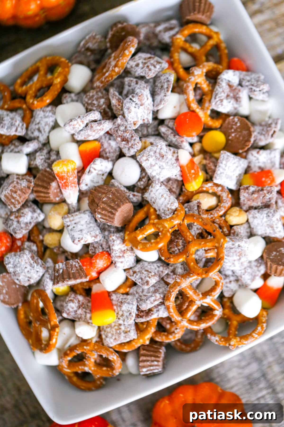 Monster Mash Puppy Chow 2 Halloween Party Puppy Chow mix recipe - a delicious and easy no-bake snack for your spooky celebrations, featuring chocolate, peanut butter, and festive candies.
