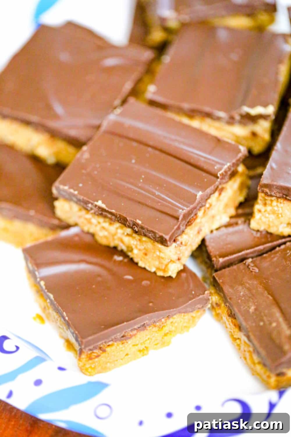Easy 5-Ingredient Peanut Butter Bars 2 Delicious 5-Ingredient No-Bake Peanut Butter Bars stacked on a plate
