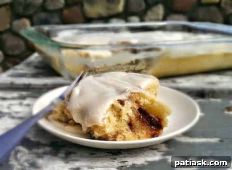 Ultimate Cinnabon Cinnamon Roll Cake 4 Finished Cinnabon Cinnamon Roll Cake with a generous drizzle of cream cheese glaze