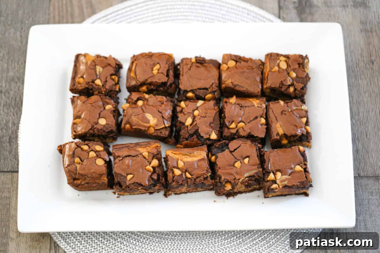 Rich and Gooey Buckeye Brownie Bars 9 Rich and fudgy ooey gooey buckeye brownie bars recipe with peanut butter and chocolate on a cooling rack
