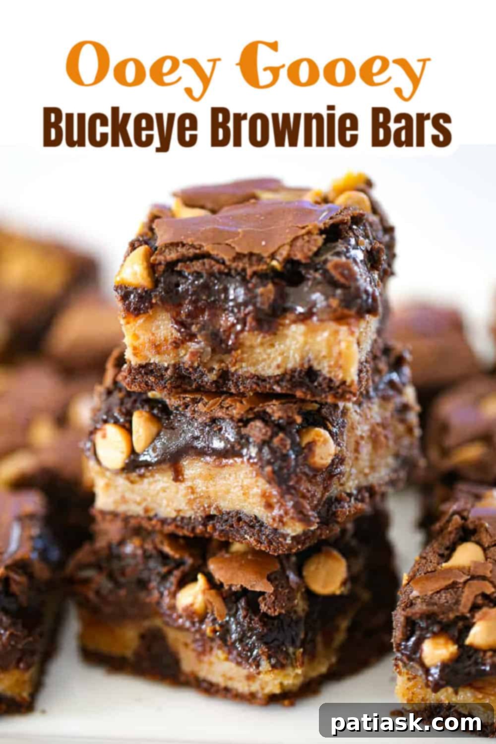 Rich and Gooey Buckeye Brownie Bars 10 Stack of gooey buckeye brownie bars, featuring the thick peanut butter layer