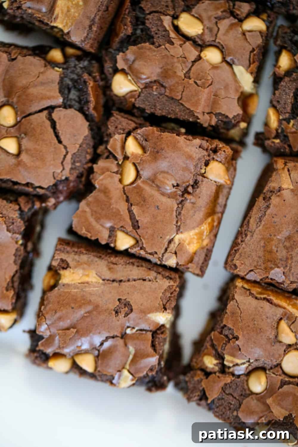 Rich and Gooey Buckeye Brownie Bars 6 Ingredients for buckeye brownies arranged on a counter: brownie mix, eggs, oil, sweetened condensed milk, peanut butter, and peanut butter chips