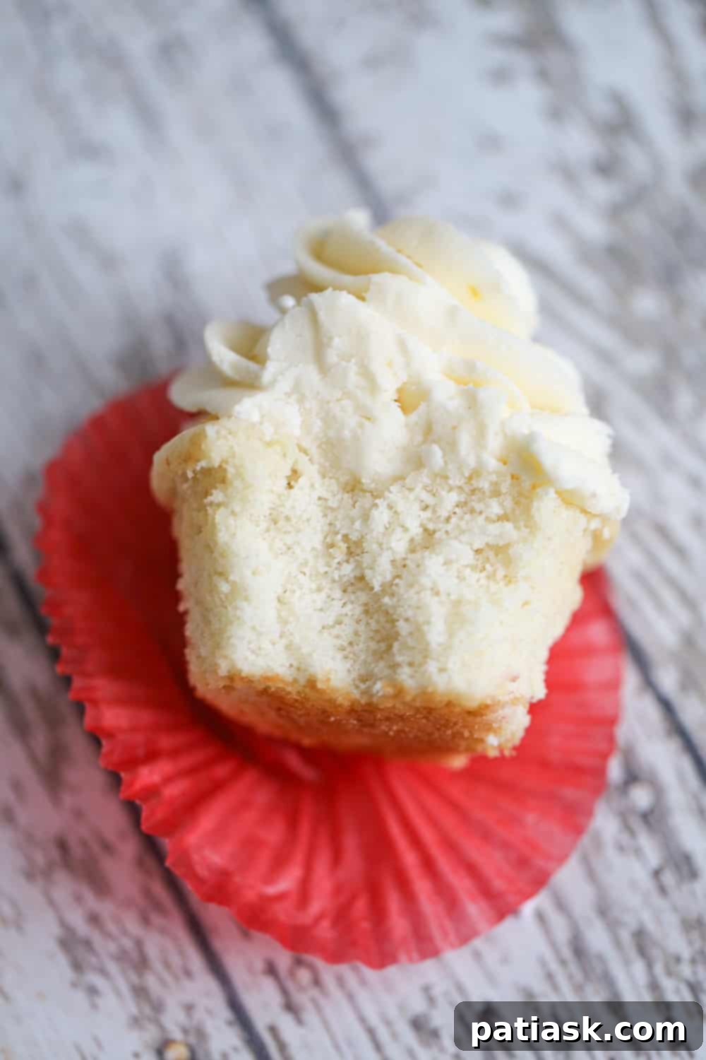 Dreamy White Chocolate Buttercream Cupcakes 3 Close-up of a White Chocolate Buttercream Cupcake with elegant frosting swirls