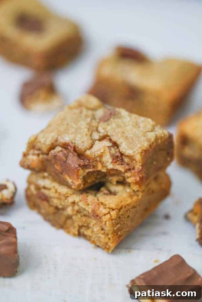 Heavenly Snickers Peanut Butter Blondies 4 A tray of freshly baked Snickers Peanut Butter Blondies, cut into perfect squares.