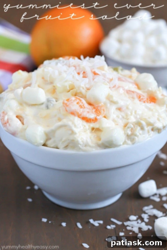 yummiest-fruit-salad-ever-6 Yummiest Fruit Salad Ever from Yummy Healthy Easy, a light and fluffy dessert with pineapple, mandarins, grapes, marshmallows, and coconut in a creamy dressing.